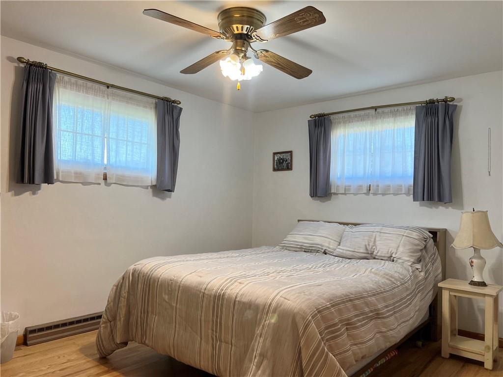 119 Walnut Street Apollo, PA 15613 - Photo 12 of 26 a bedroom with a bed and a chandelier