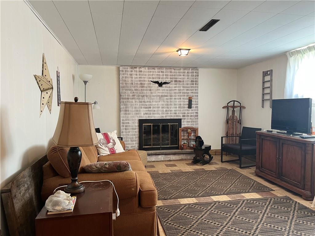 119 Walnut Street Apollo, PA 15613 - Photo 17 of 26 a living room with furniture a fireplace and a flat screen tv