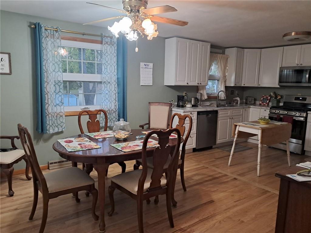 119 Walnut Street Apollo, PA 15613 - Photo 5 of 26 a dining room with wooden floor a chandelier a wooden table and chairs