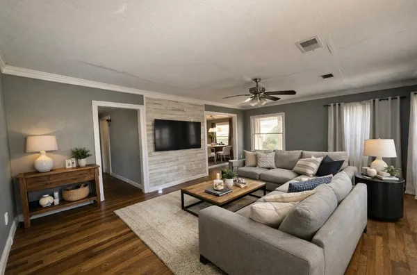 a living room with furniture and a flat screen tv