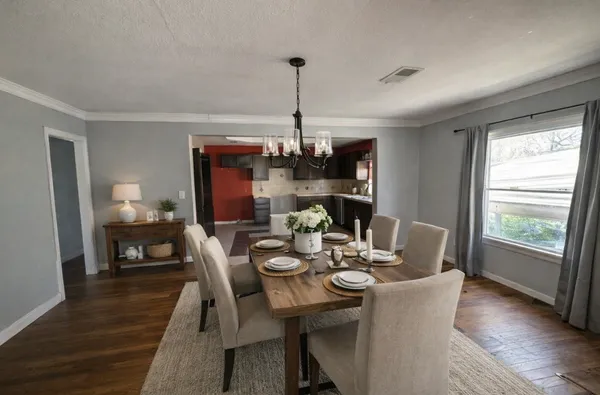 a dining room with furniture window and wooden floor