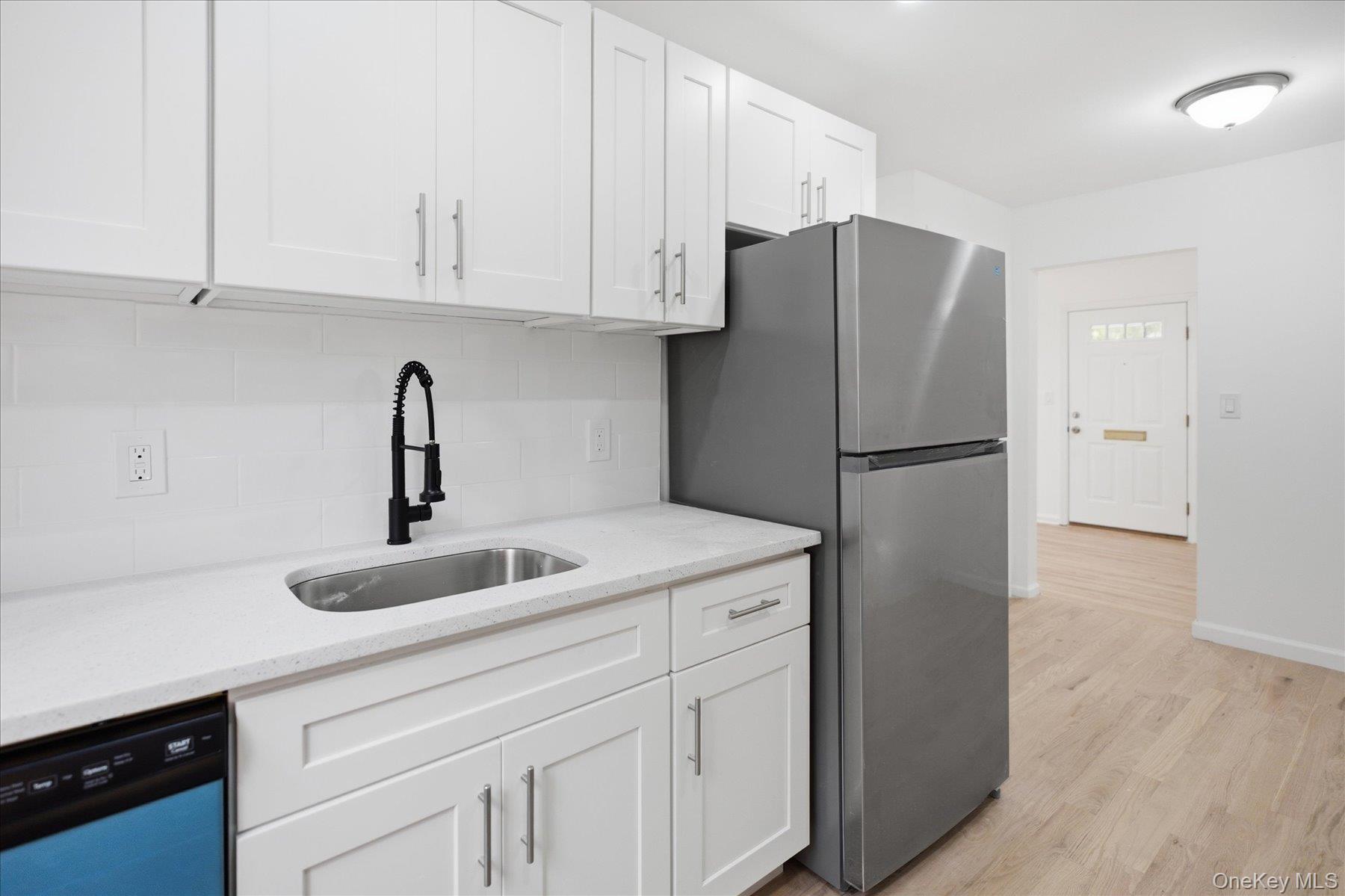 117 Robins Road, Unit 117 New Rochelle, NY 10801 - Photo 11 of 28 a kitchen with refrigerator and cabinets