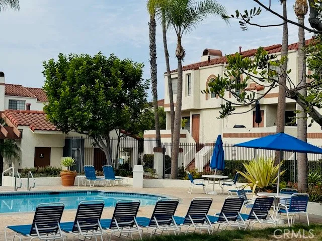 a front view of multiple houses with yard