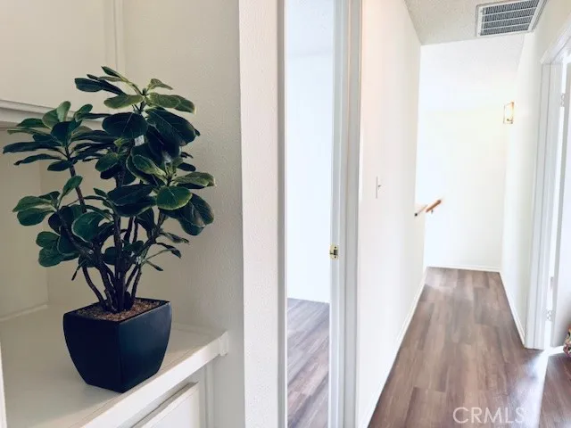 a vase of flowers sitting on a floor