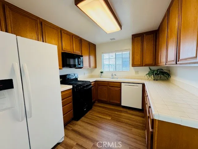 a kitchen with a refrigerator a sink a stove a microwave and cabinets