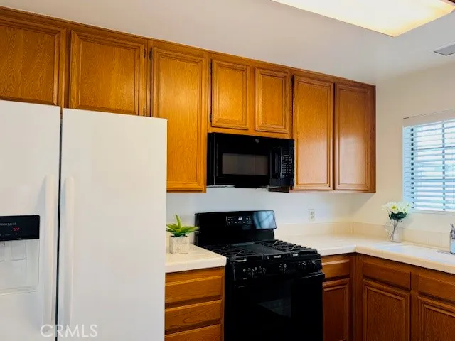 a kitchen with a sink and a stove top oven