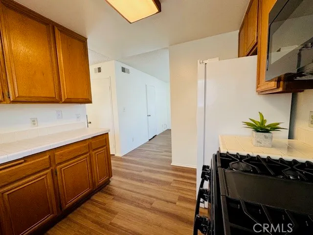 a kitchen with stainless steel appliances a stove a sink and a refrigerator