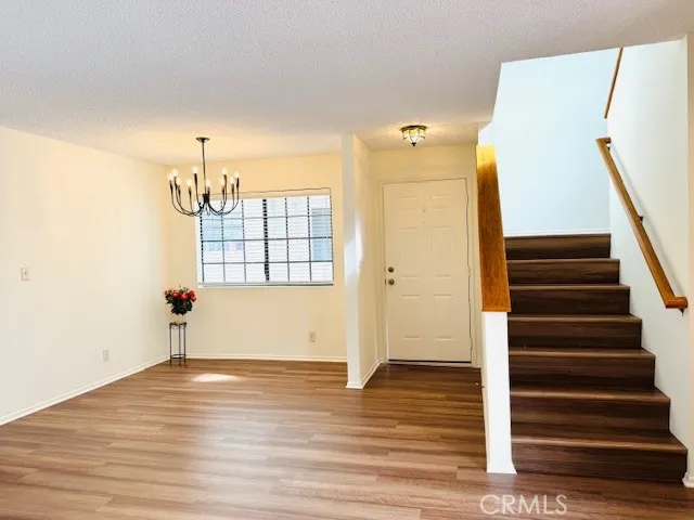 a view of entryway and hall with wooden floor