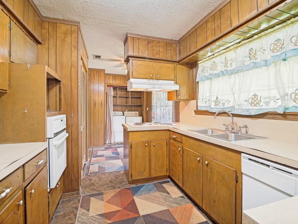 1081 Wright Street Terrell, TX 75160 - Photo 18 of 29 Kitchen with wood-paneled walls and ceiling trim