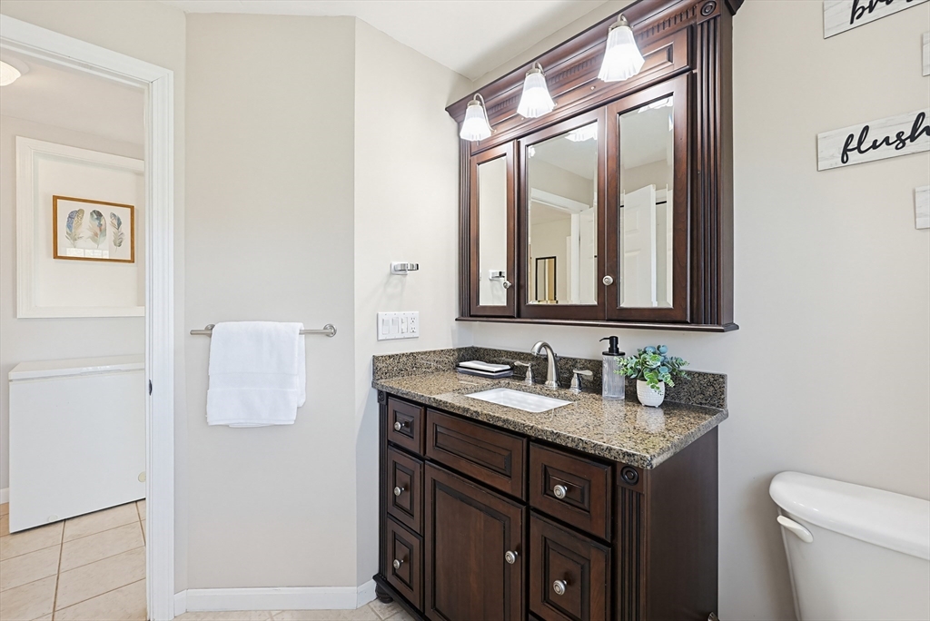 18 Anchorage Road Franklin, MA 02038 - Photo 20 of 42 a bathroom with a granite countertop sink and a mirror