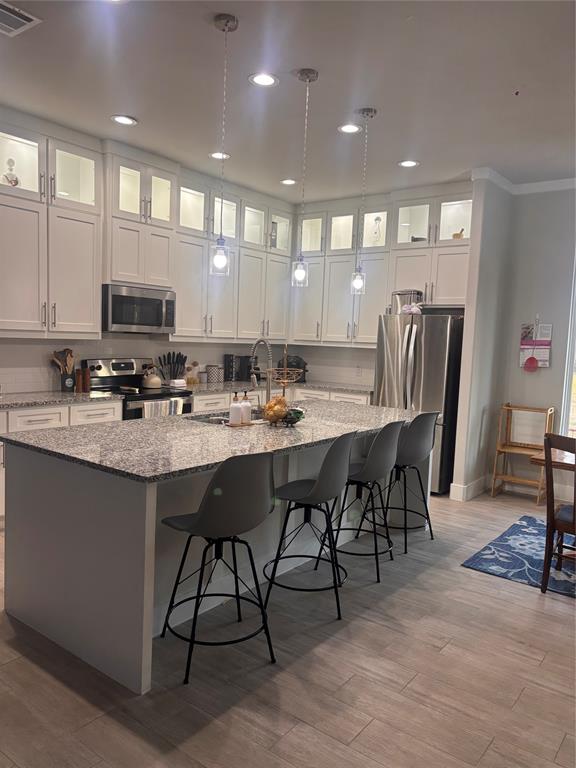 213 Sperry Lane Red Oak, TX 75154 - Photo 3 of 6 a kitchen with stainless steel appliances granite countertop a stove a sink a refrigerator a dining table and chairs