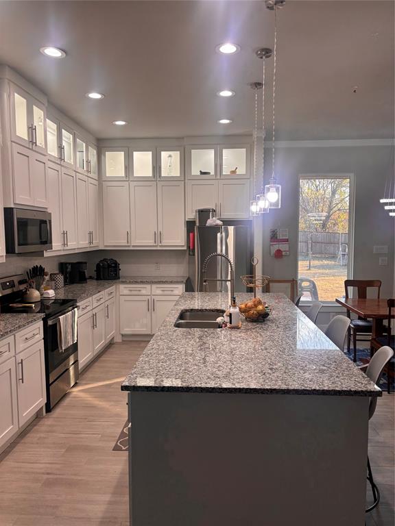 213 Sperry Lane Red Oak, TX 75154 - Photo 4 of 6 a kitchen with kitchen island granite countertop a stove a sink a counter space and cabinets