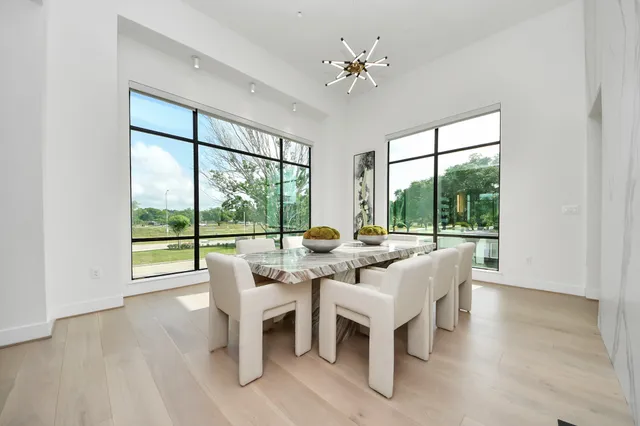 a dining room with furniture window and wooden floor
