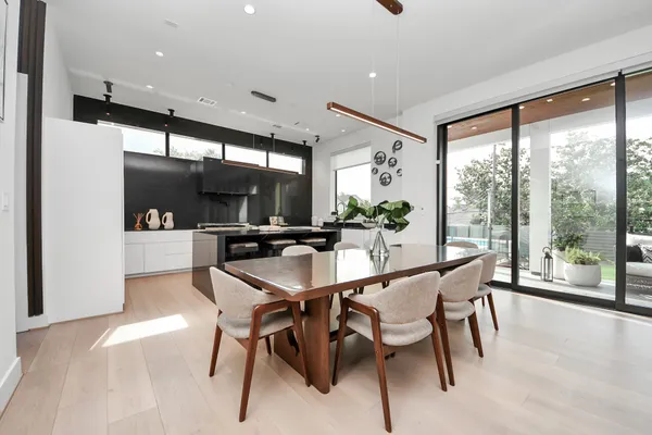 a dining room with furniture and a large window