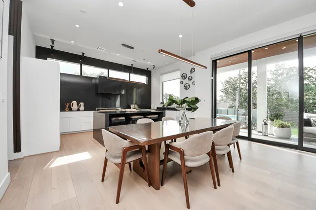 a dining room with furniture and a large window