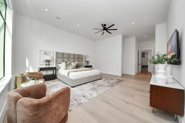 a living room with furniture and a wooden floor