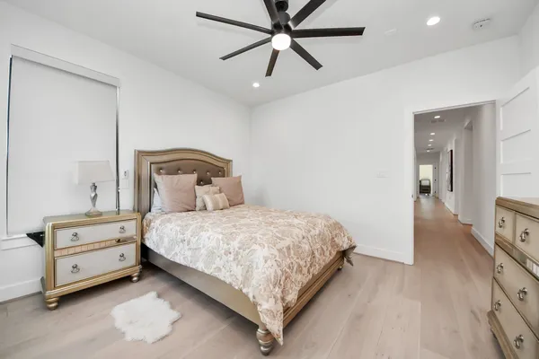 a bedroom with a bed and wooden floor