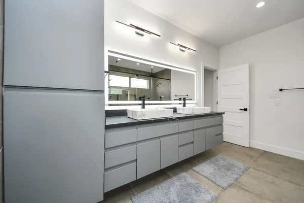 a bathroom with a double vanity sink and a mirror