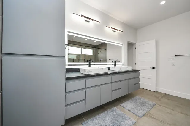 a bathroom with a double vanity sink and a mirror