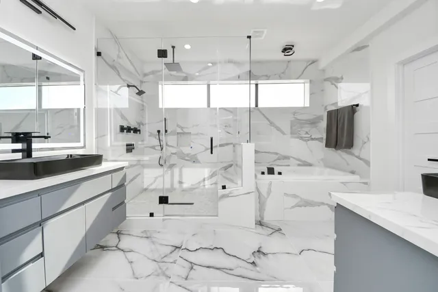 a large white kitchen with a large window