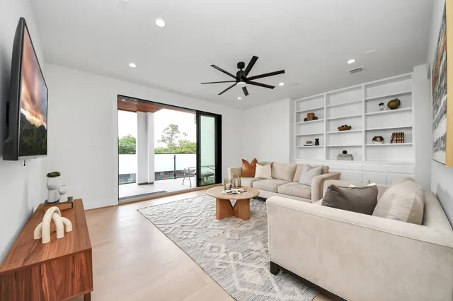 a living room with furniture fireplace and flat screen tv