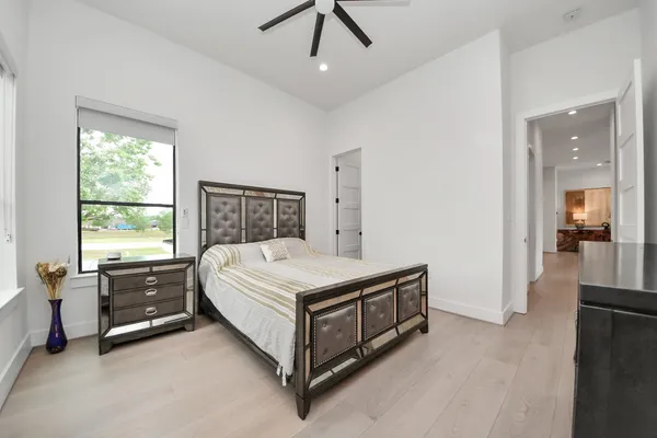a spacious bedroom with a bed and a table in it