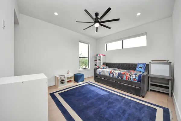a living room with a bed furniture and a window