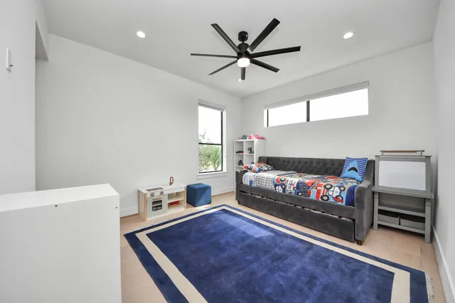 a living room with a bed furniture and a window