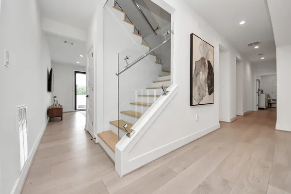 a view of entryway and hall with wooden floor