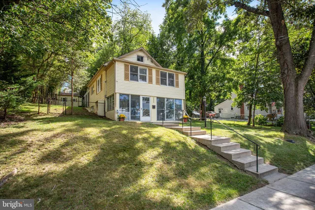 a front view of a house with a yard table and chairs