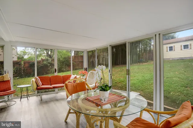 a living room with couch and a floor to ceiling window