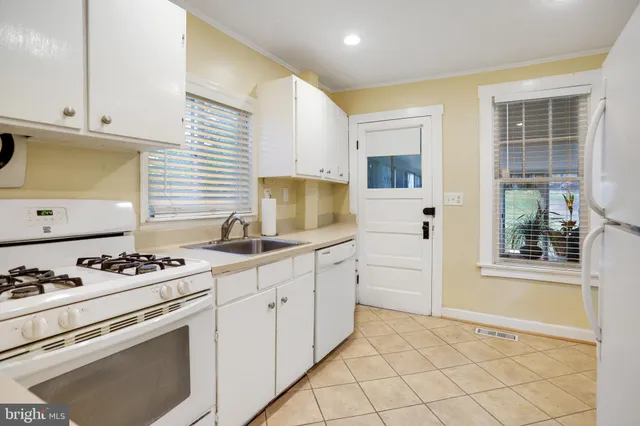 a kitchen with granite countertop cabinets and window