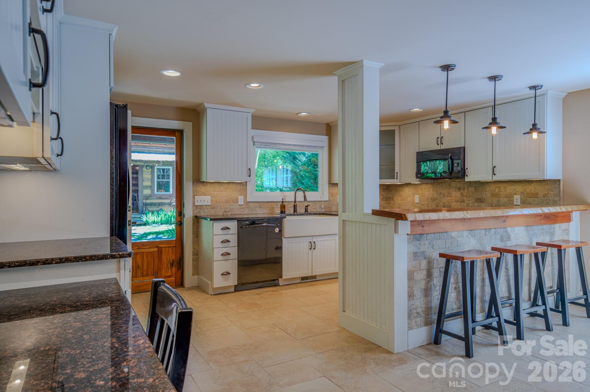 75 Old Gap Creek Road Fairview, NC 28730 - Photo 13 of 43 a kitchen with stainless steel appliances granite countertop a refrigerator and a stove top oven