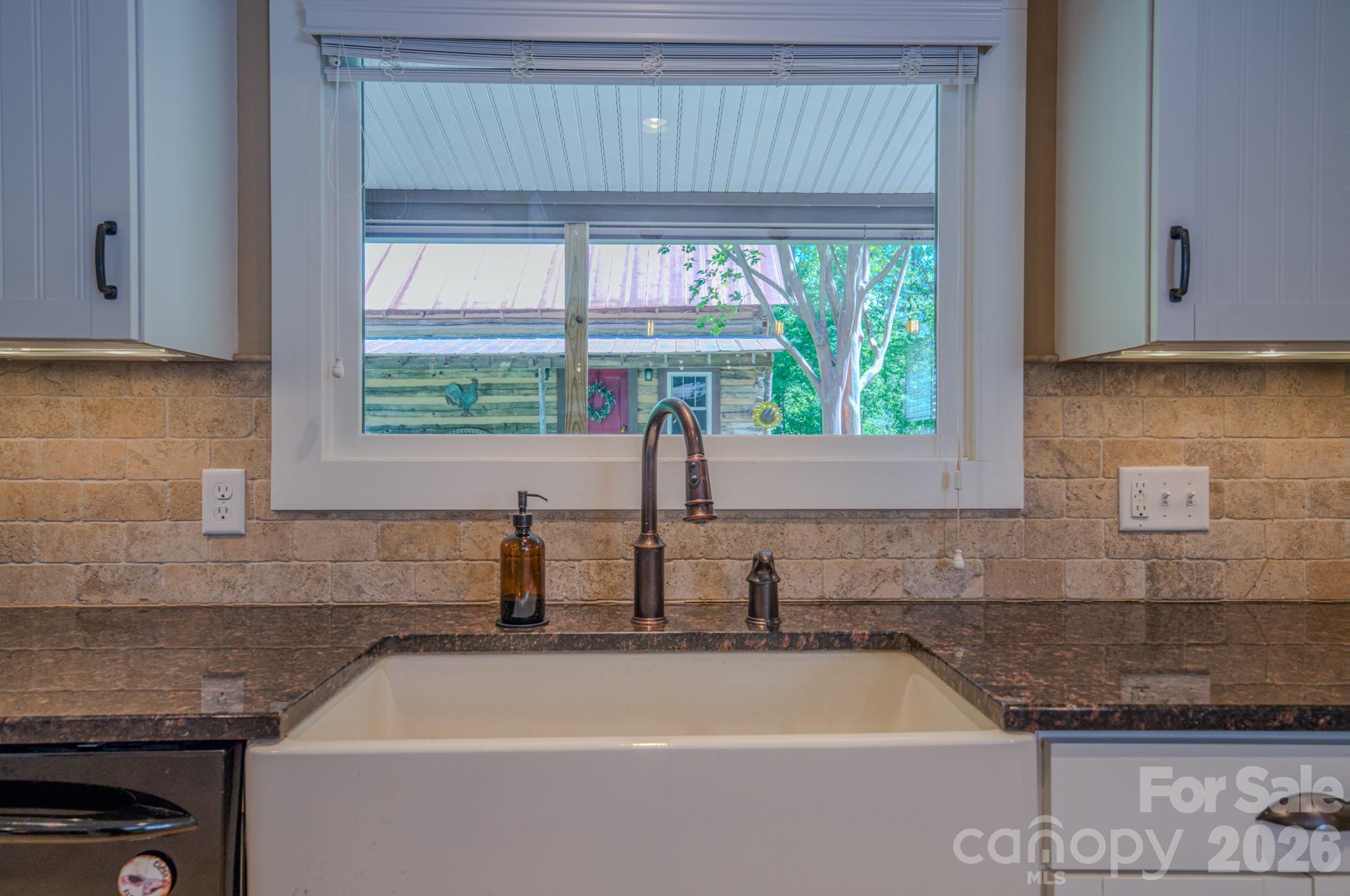 75 Old Gap Creek Road Fairview, NC 28730 - Photo 14 of 43 a kitchen with a sink a window and stainless steel appliances