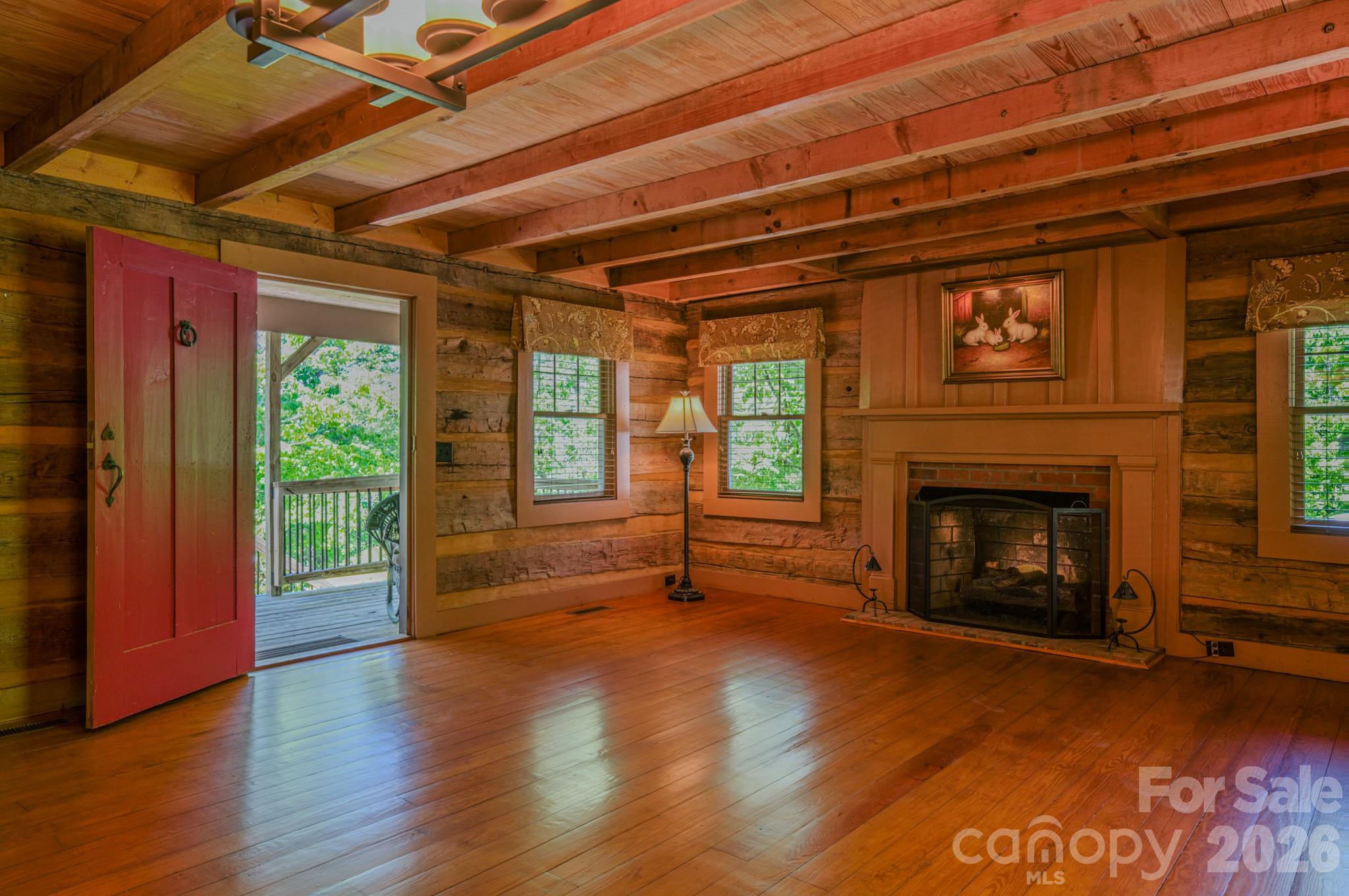 75 Old Gap Creek Road Fairview, NC 28730 - Photo 21 of 43 a view of an empty room with wooden floor fireplace and a window
