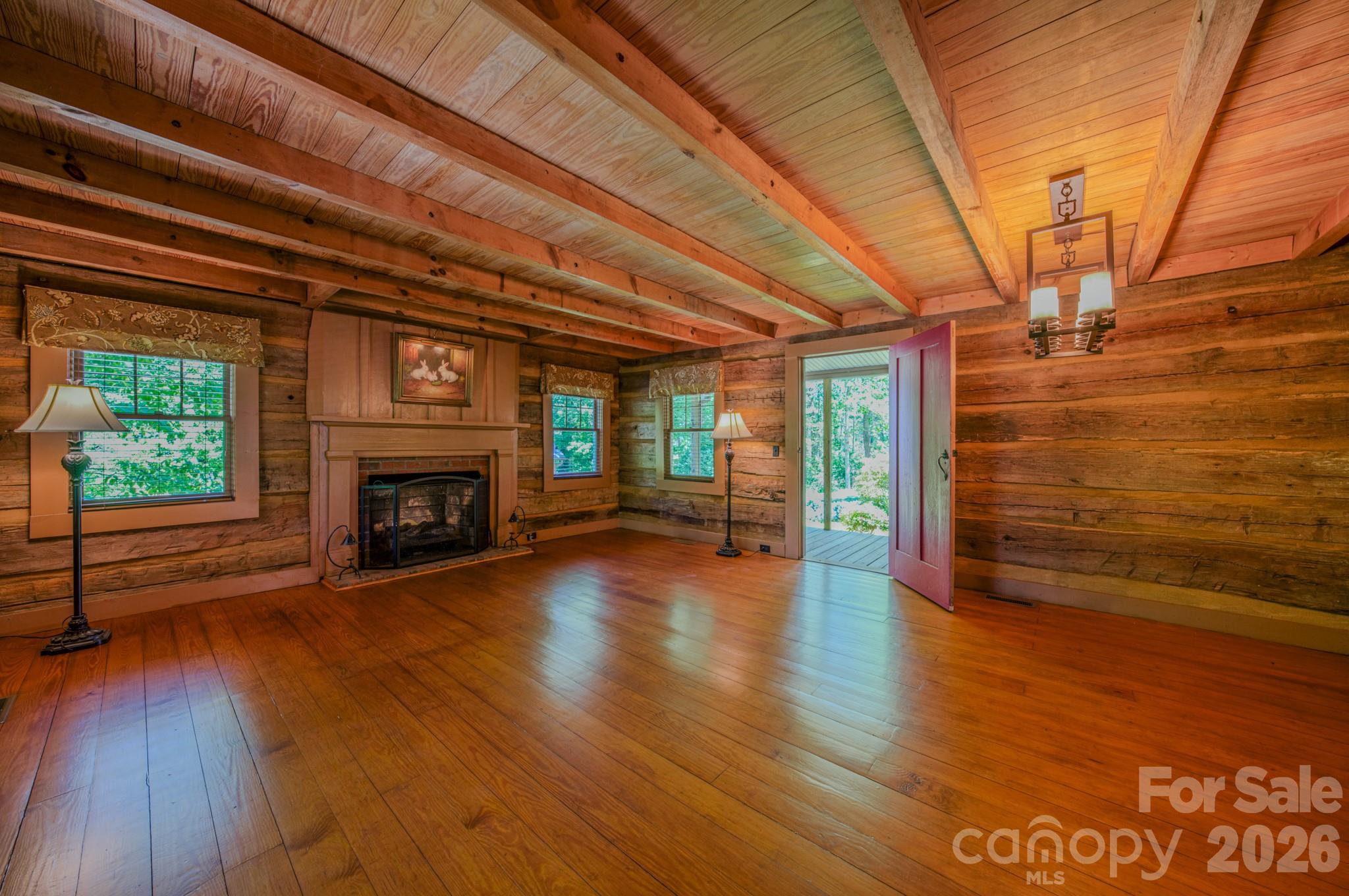 75 Old Gap Creek Road Fairview, NC 28730 - Photo 22 of 43 a view of empty room with wooden floor and fireplace
