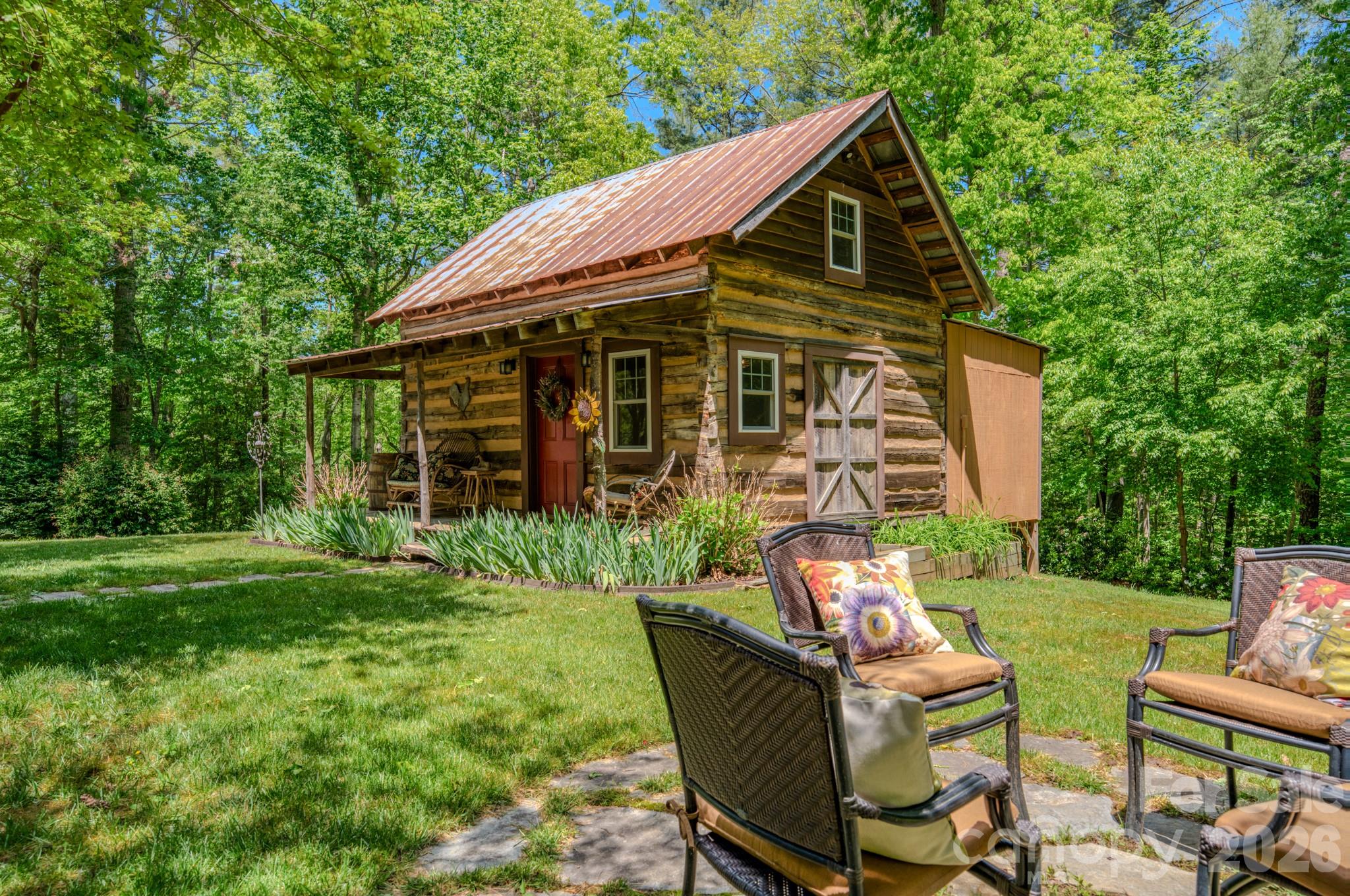 75 Old Gap Creek Road Fairview, NC 28730 - Photo 5 of 43 a backyard of a house with table and chairs