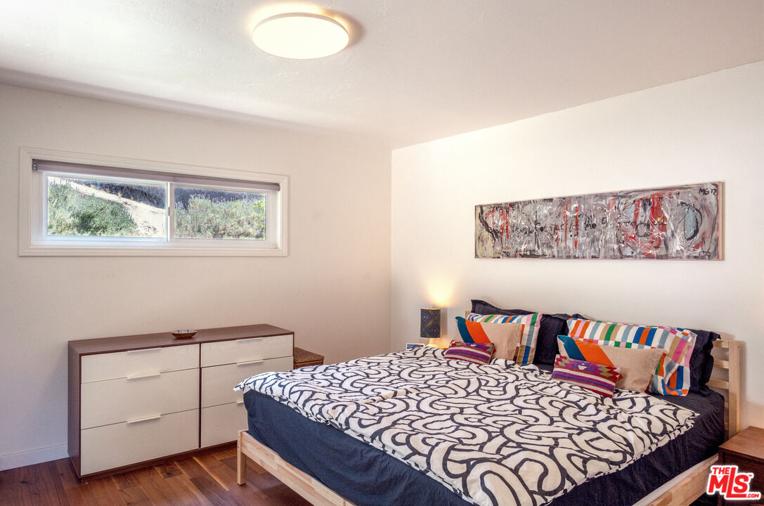 25166 Wheeler Road Newhall, CA 91321 - Photo 23 of 52 a bedroom with a large bed and a lamp
