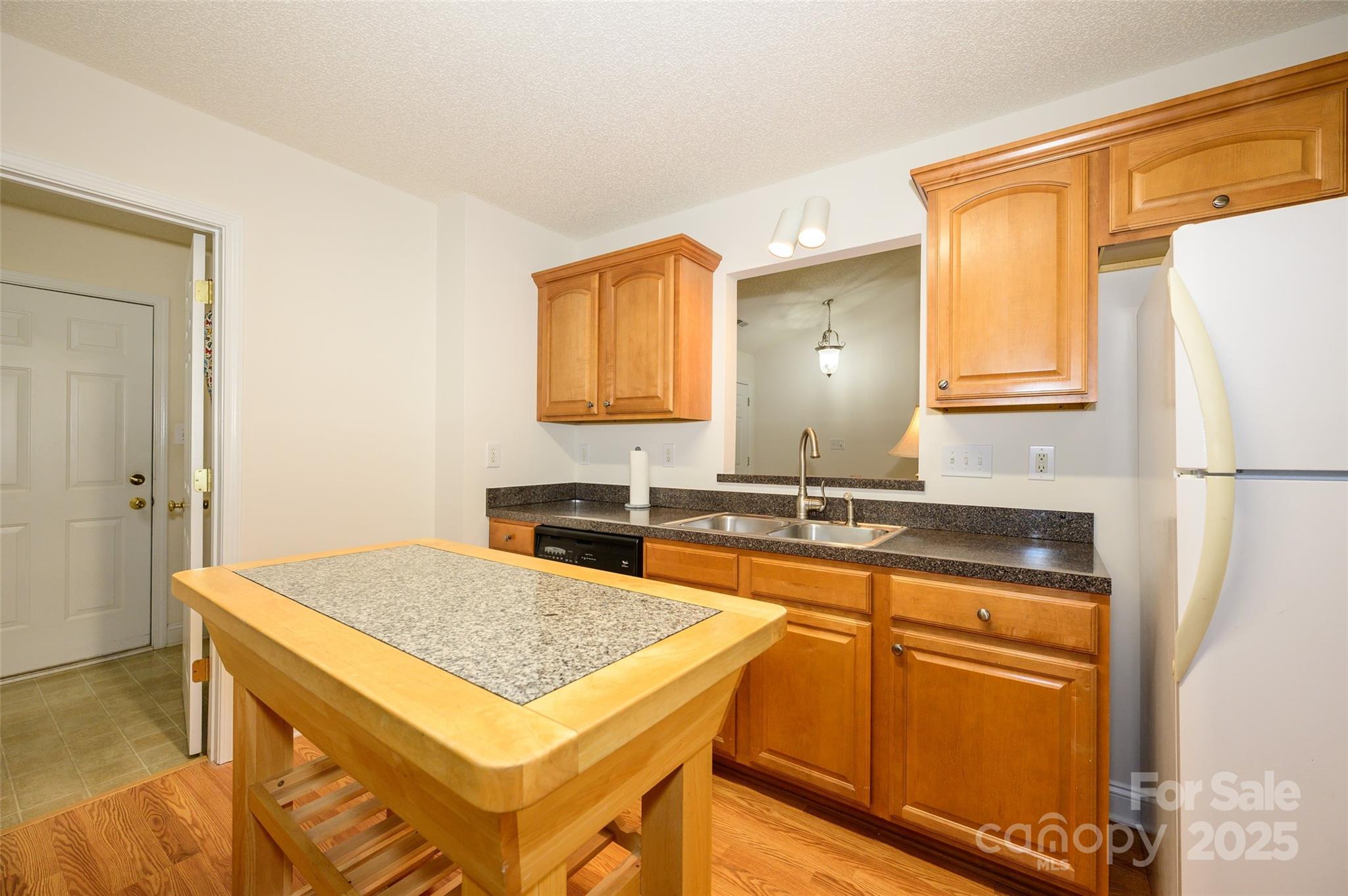 12617 Hill Pine Road Midland, NC 28107 - Photo 12 of 42 a kitchen with a sink a stove and refrigerator