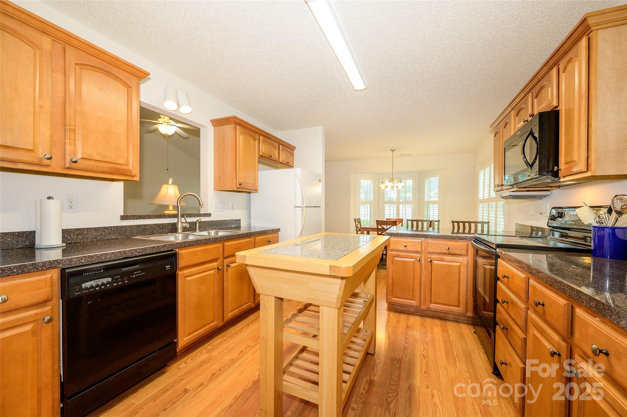 12617 Hill Pine Road Midland, NC 28107 - Photo 13 of 42 a kitchen with stainless steel appliances granite countertop a sink a stove and a refrigerator