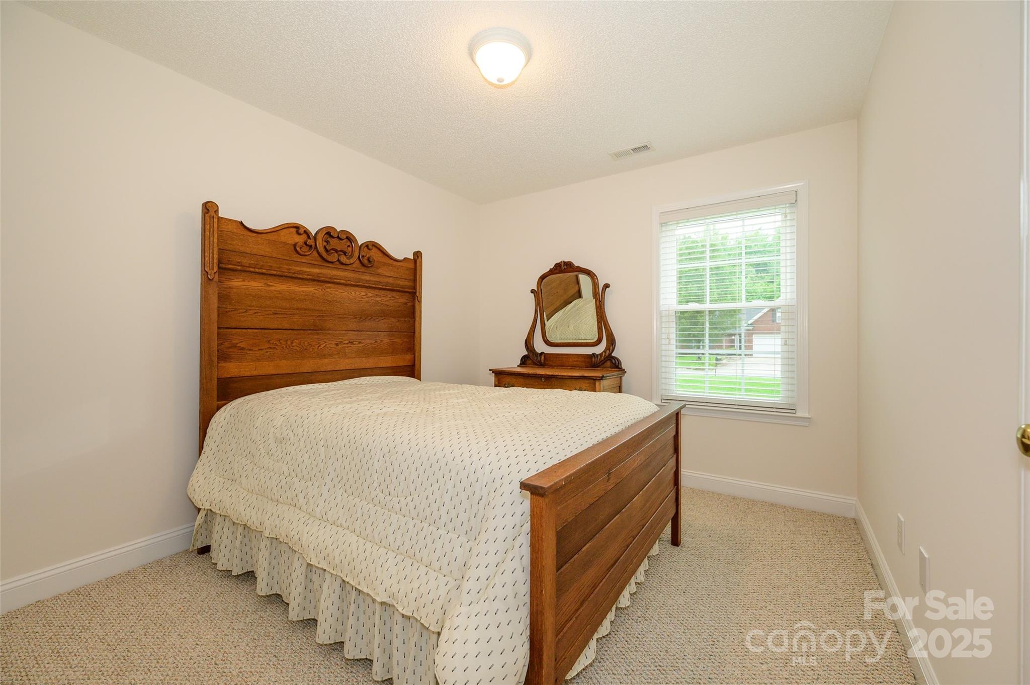 12617 Hill Pine Road Midland, NC 28107 - Photo 16 of 42 a bedroom with a bed and a window