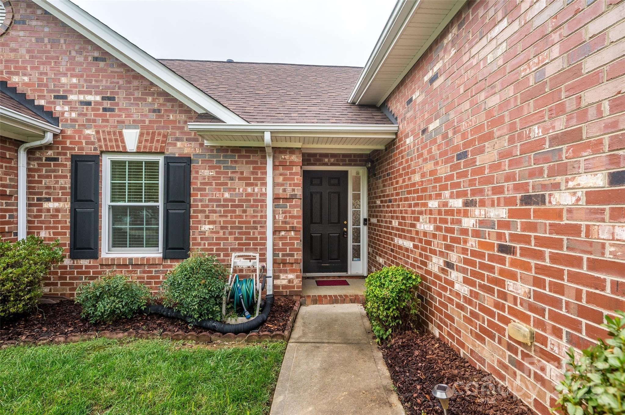 12617 Hill Pine Road Midland, NC 28107 - Photo 2 of 42 front view of a brick house with a yard