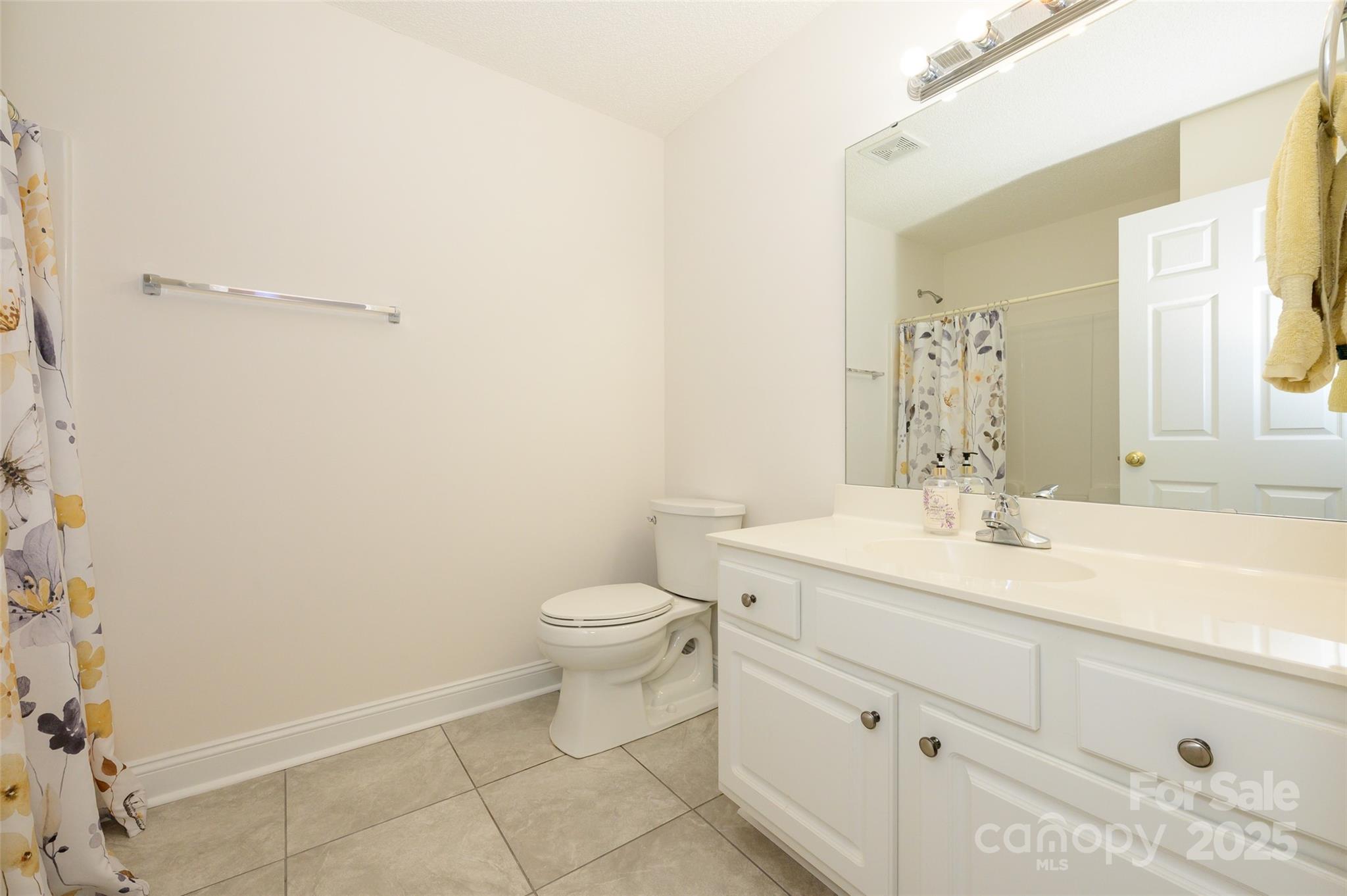 12617 Hill Pine Road Midland, NC 28107 - Photo 22 of 42 a bathroom with a granite countertop sink mirror vanity and toilet