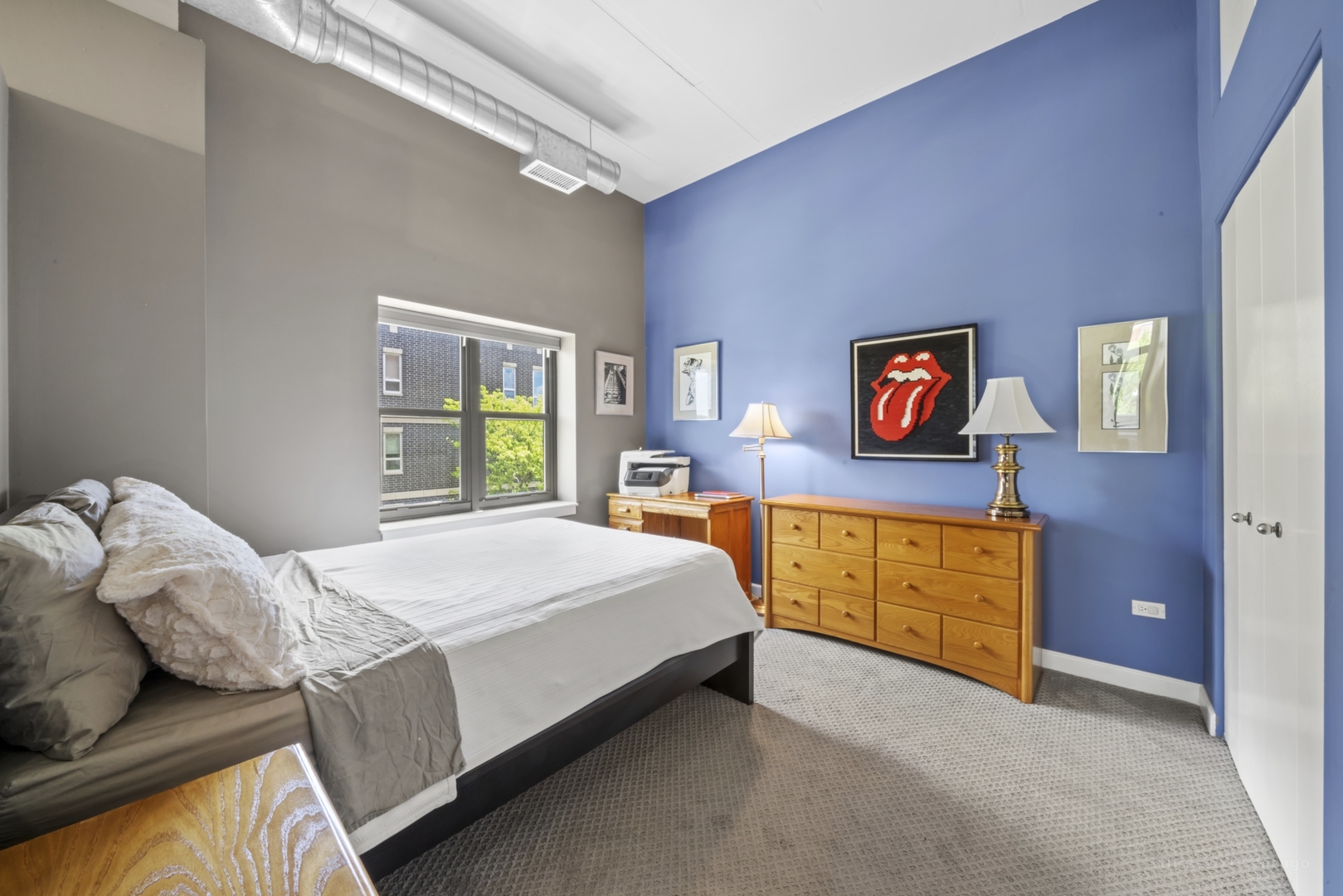 1301 West Madison Street, Unit 308 Chicago, IL 60607 - Photo 15 of 21 a bedroom with a bed and dresser