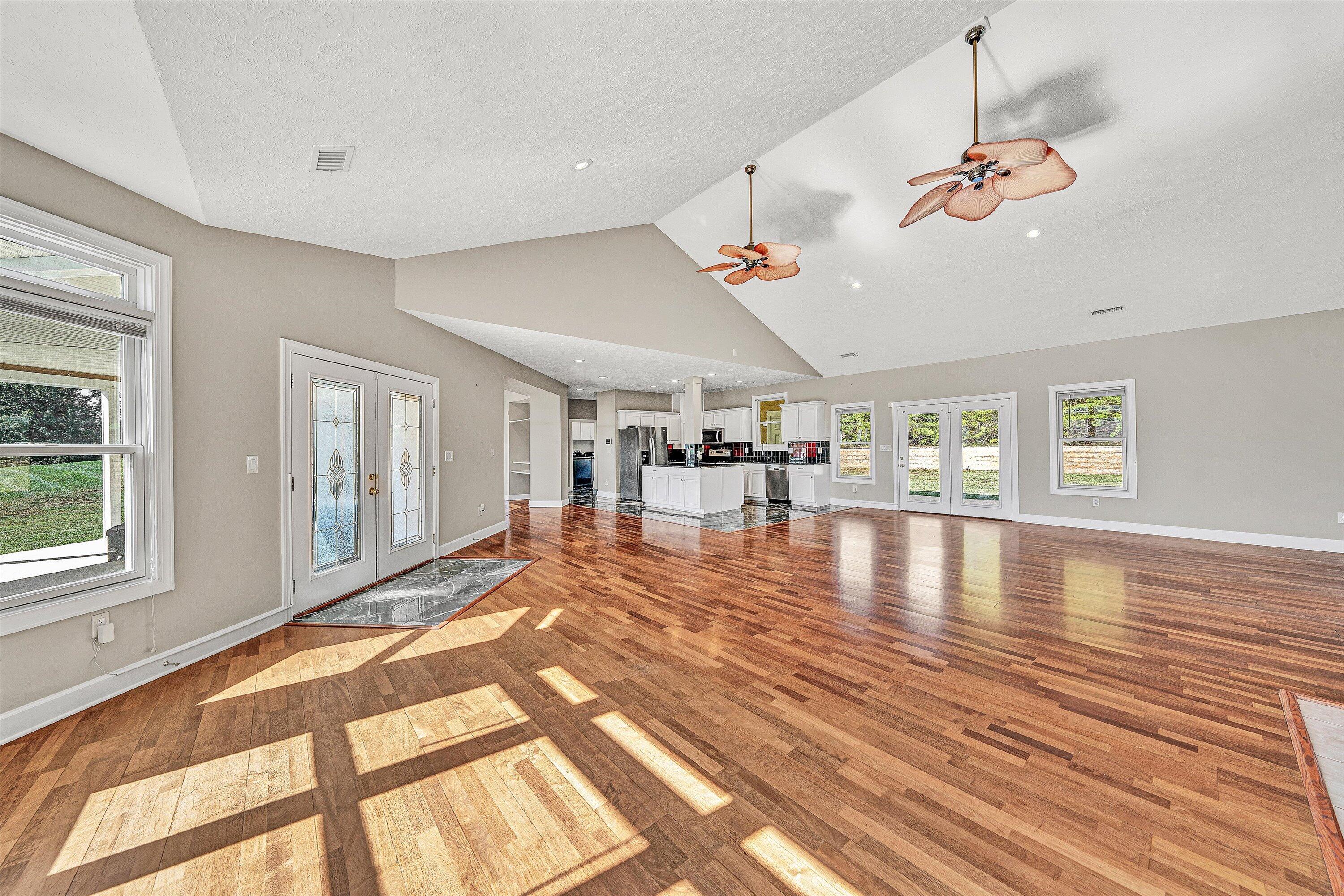 537 Calypso Road Moneta, VA 24121 - Photo 14 of 55 a view of a living room and kitchen floor with a ceiling fan