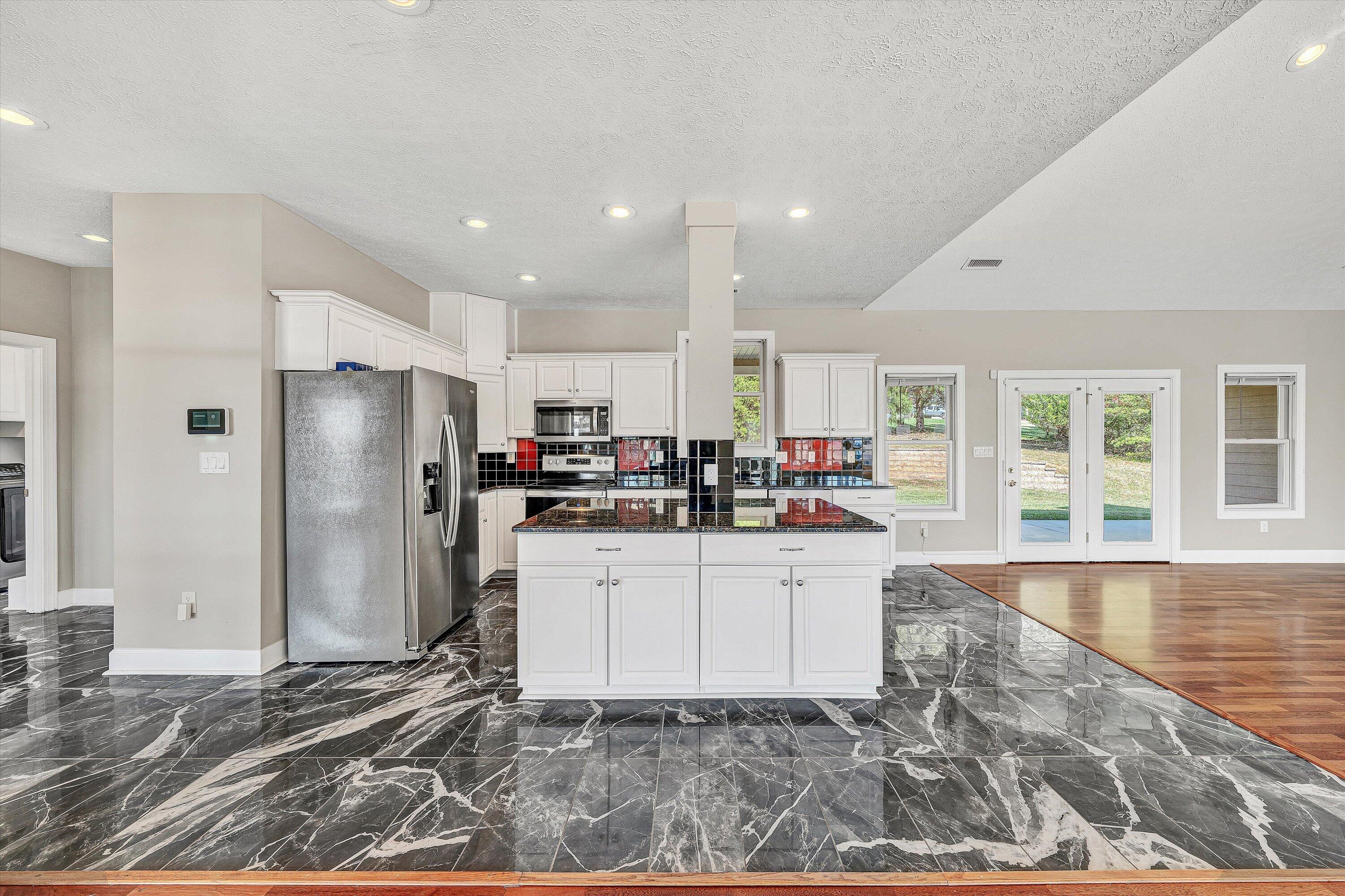 537 Calypso Road Moneta, VA 24121 - Photo 15 of 55 a kitchen with stainless steel appliances kitchen island granite countertop a refrigerator and a stove top oven