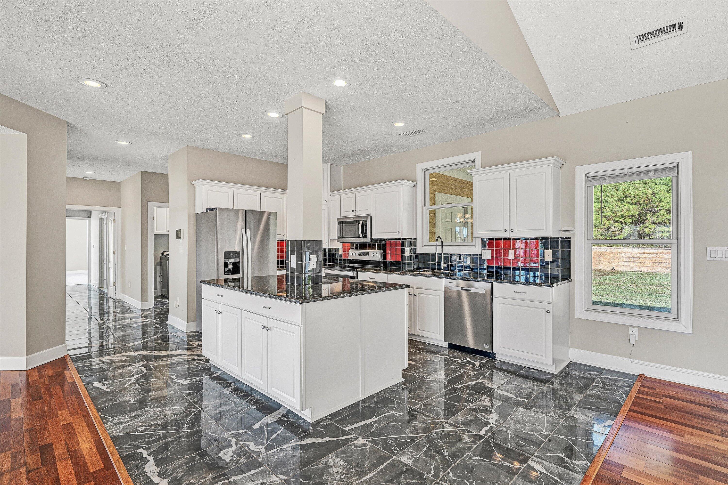 537 Calypso Road Moneta, VA 24121 - Photo 16 of 55 a kitchen that has a lot of white cabinets and stainless steel appliances