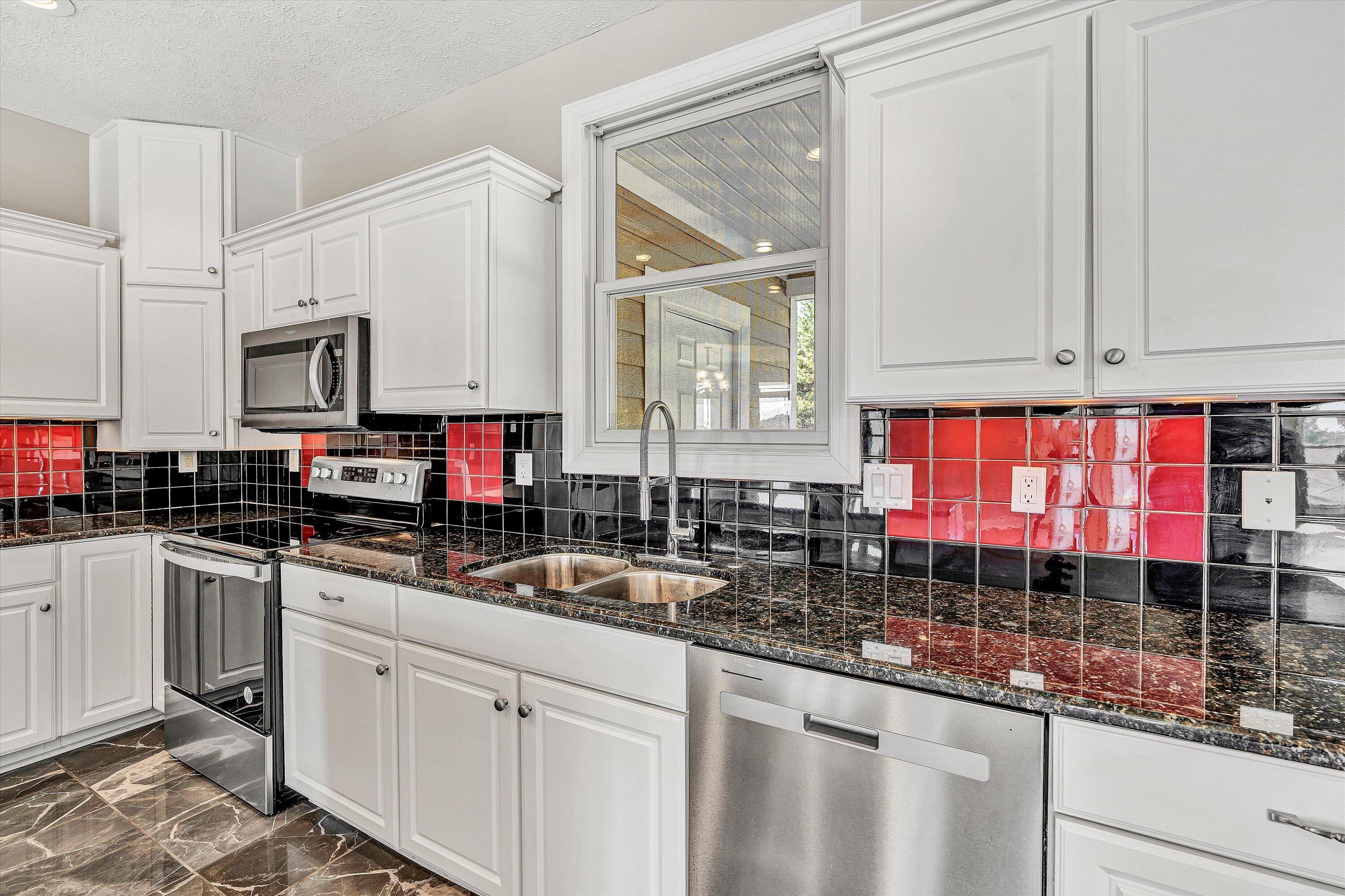 537 Calypso Road Moneta, VA 24121 - Photo 18 of 55 a kitchen with stainless steel appliances granite countertop a stove a sink and a microwave