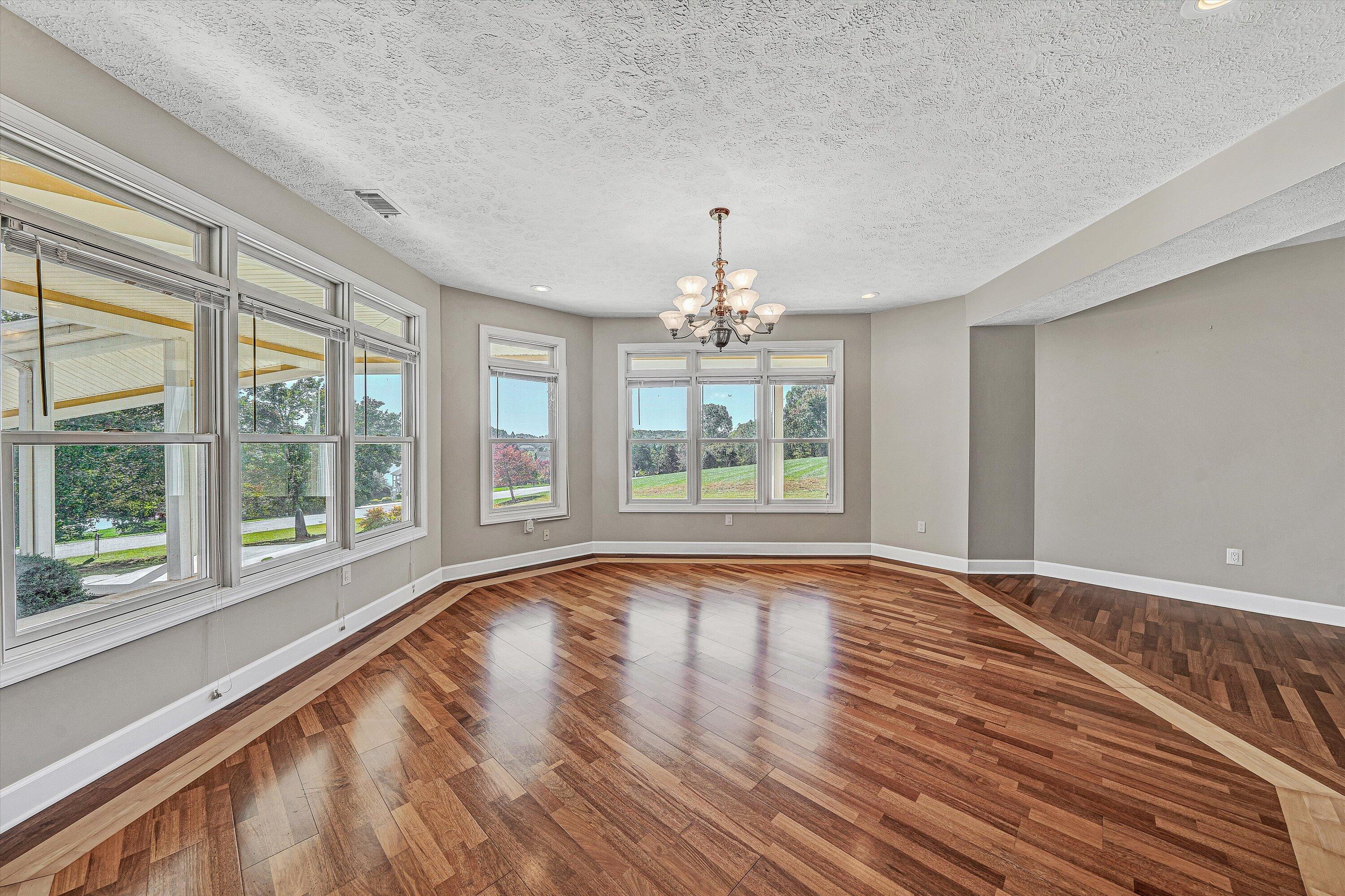 537 Calypso Road Moneta, VA 24121 - Photo 20 of 55 a view of an empty room with wooden floor and a window