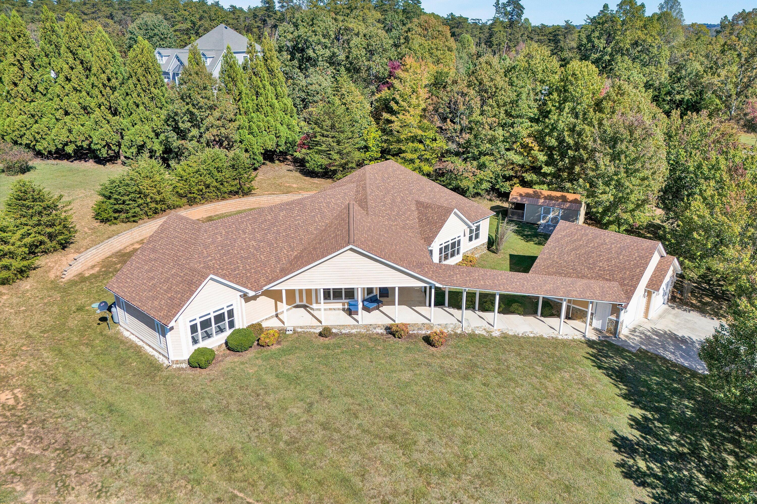 537 Calypso Road Moneta, VA 24121 - Photo 2 of 55 an aerial view of a house with swimming pool and large trees